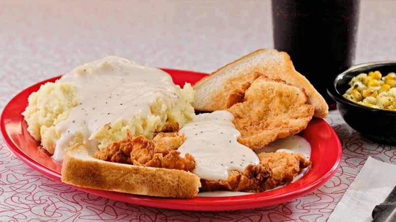 Pork chop meal at Boomarang Diner with a side of roasted corn