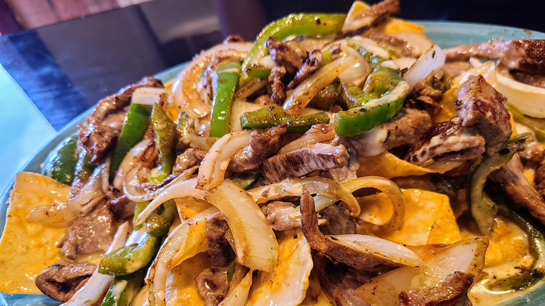 Nachos with grilled onions, peppers, and chicken