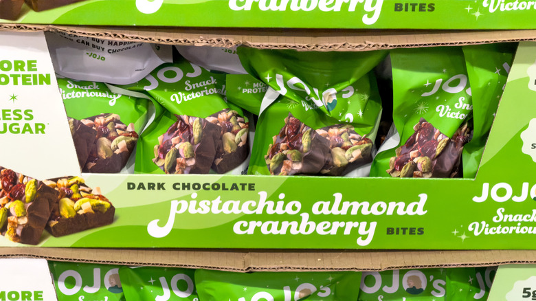 A bag of dark chocolate, pistachio, almond and cranberry bites in green packaging