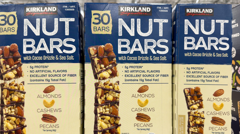 Several boxes of Kirkland Signature Nut Bars at Costco.