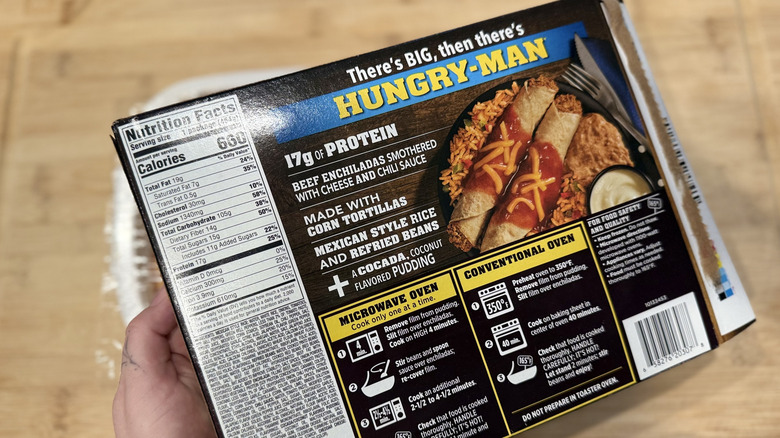Hand holding the back of a Hungry-Man frozen meal box