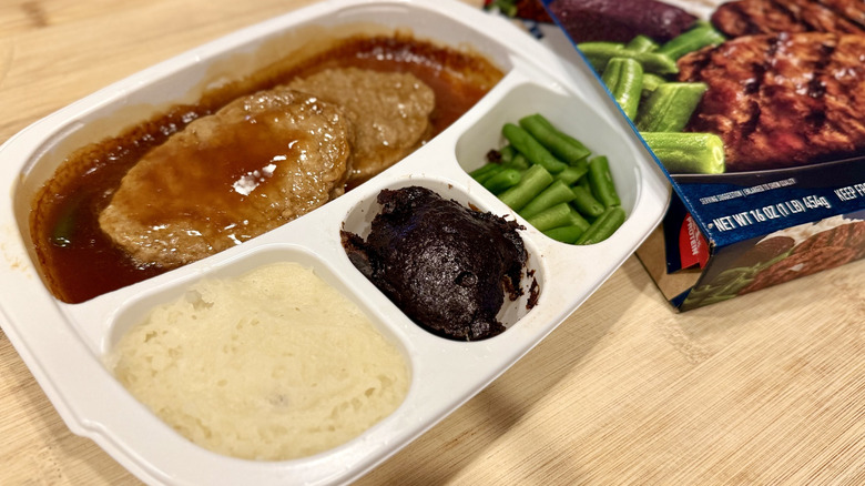 Salisbury Steak in a white tray next to the packaging
