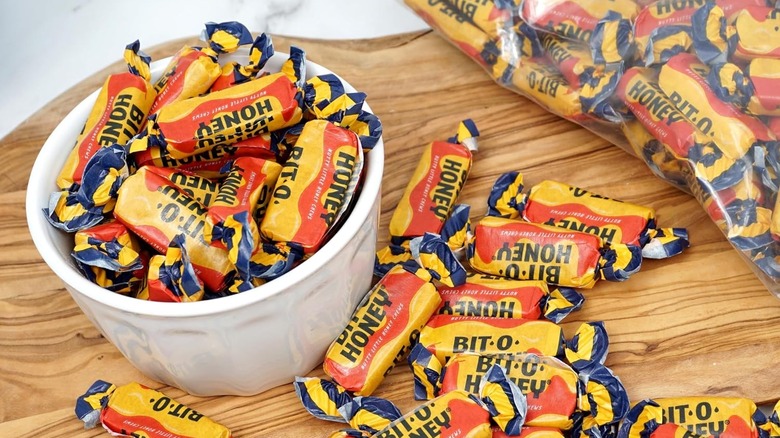 multiple honey taffy candies wrapped in bright yellow packaging