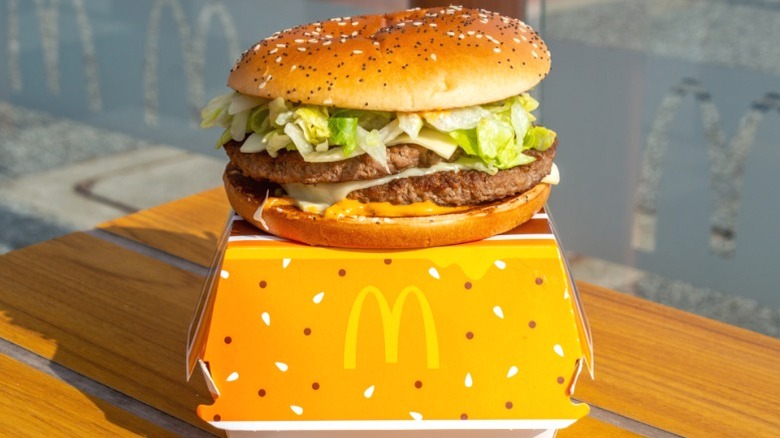 McDonald's Big Arch hamburger sitting atop its container.