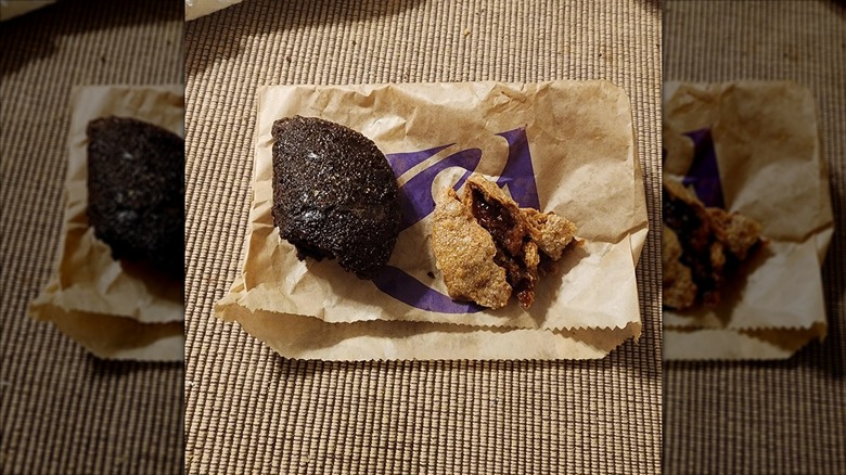 Taco Bell Chocolate Fudge and Caramel Empanadas sitting on a Taco Bell wrapper.