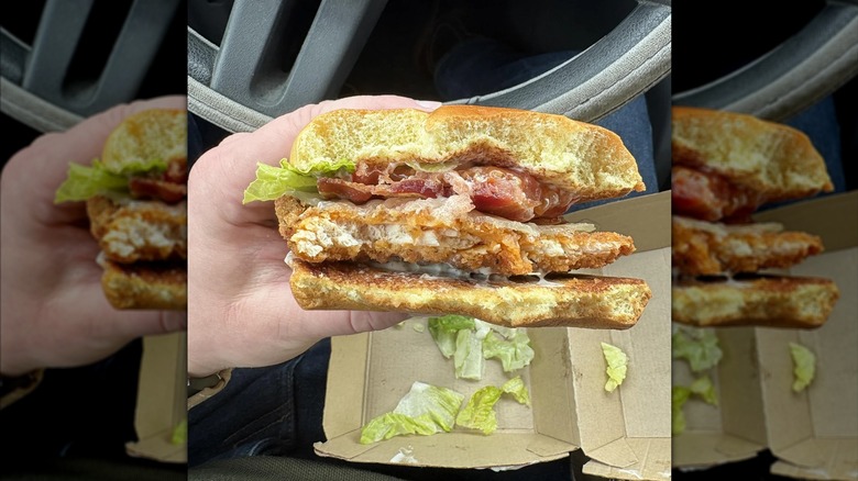 Someone holding the new Wendy's Chicken Sandwich in their car.