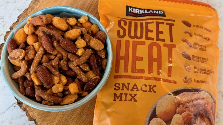 A bag and bowl full of Kirkland Signature sweet heat nut snack mix