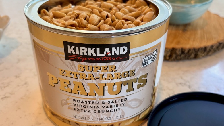 An open container of Kirkland Signature super extra-large peanuts