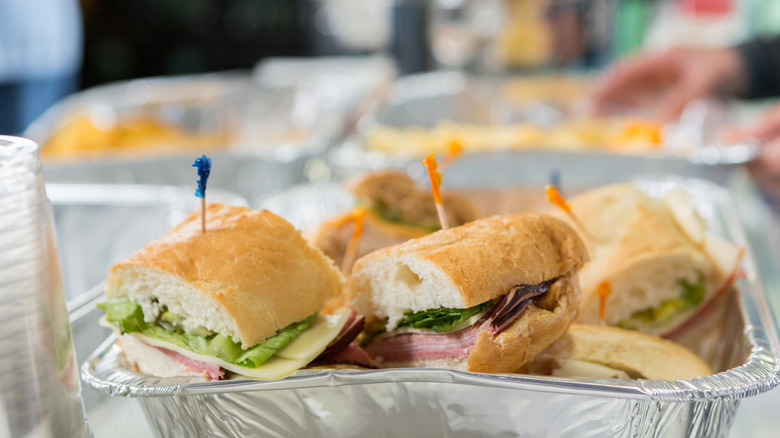 A platter of sandwiches on a buffet