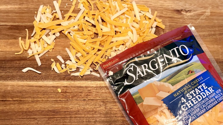 Sargento 4 State Cheddar shredded cheese on a cutting board