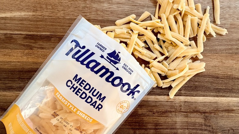 Tillamook Medium Cheddar farmstyle shreds on a cutting board