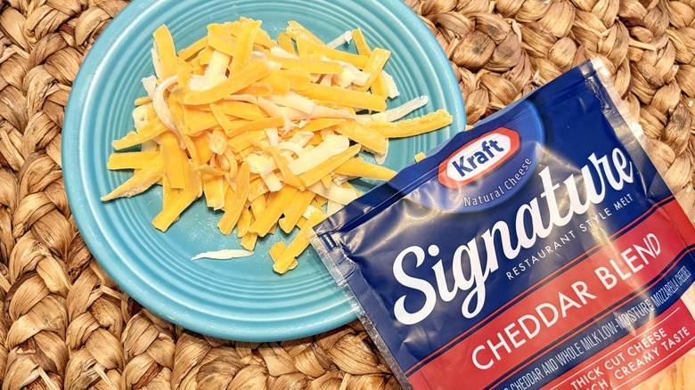 A plate of Kraft Signature shredded cheddar blend cheese