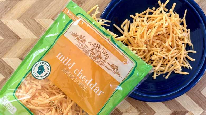 Roundy's mild cheddar shredded cheese poured on a plate