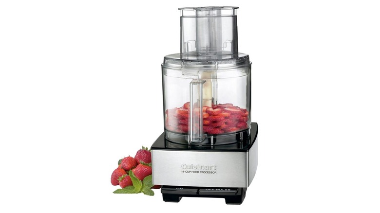 The Cuisinart Custom 14-Cup Food Processor with strawberries in and beside it
