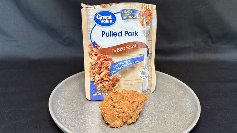Pouch of Great Value pulled pork with meat on a gray plate