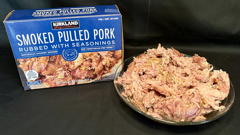 bowl of pulled pork next to Kirkland Signature packaging