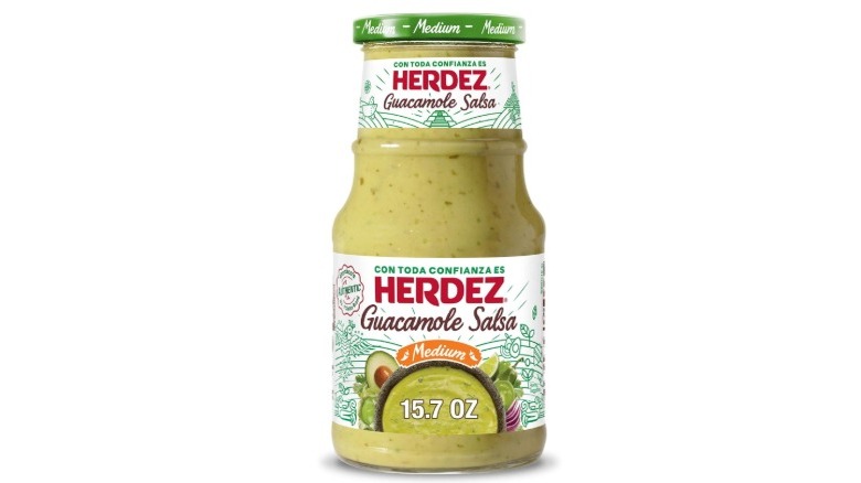 Bottle of Herdez Guacamole Salsa on white background