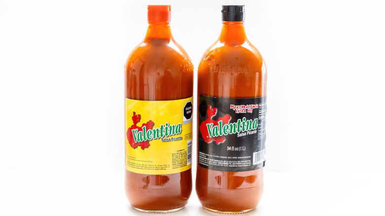 Bottle of Valentina hot sauce and bottle of Valentina Extra-Hot Salsa Picante on white background
