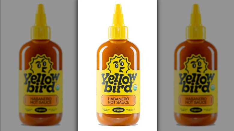 Bottle of Yellowbird Habanero Hot Sauce on white background