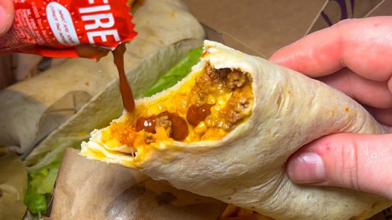 Taco Bell burrito with hot sauce