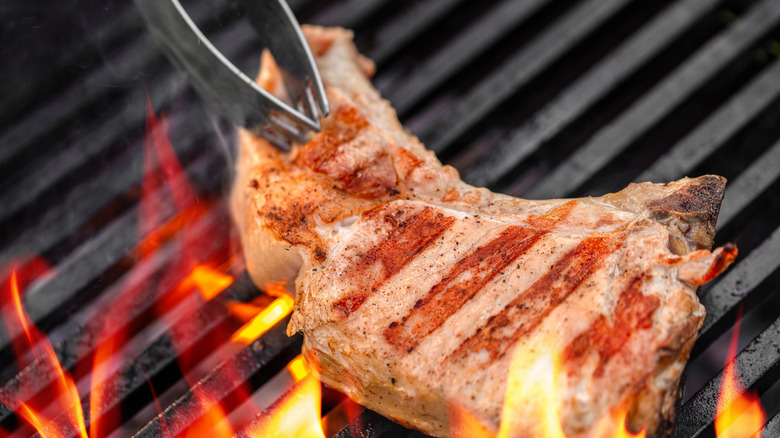A pork chop on the grill
