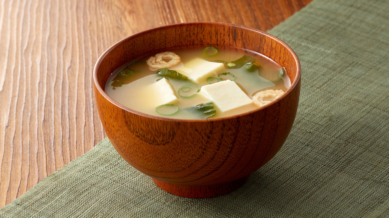 Miso soup bowl in wooden bowl on green mat