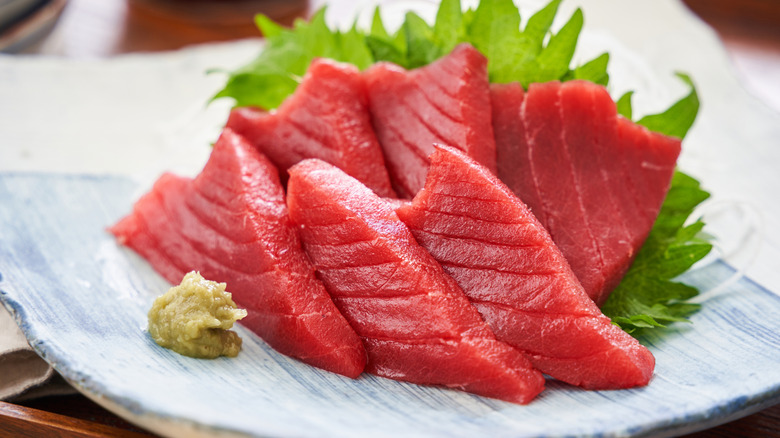 Bluefin tuna sashimi with lettuce and wasabi garnishes