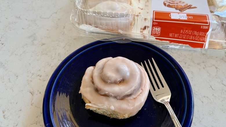 An Aldi Bake Shop cinnamon sweet roll on a plate with a fork