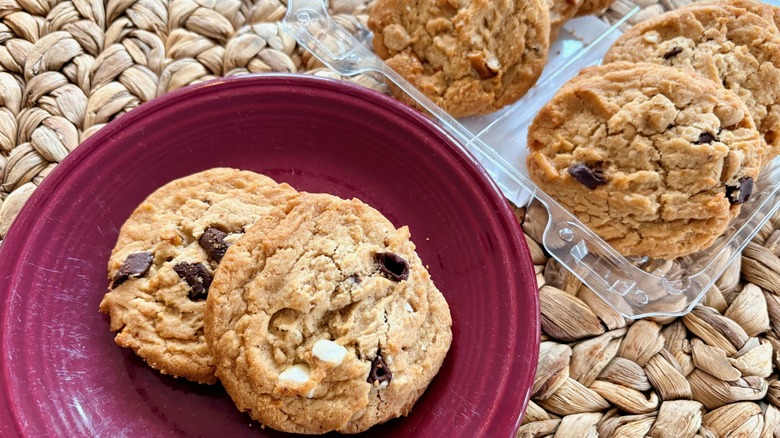 A close-up of Aldi Bake Shop Kitchen Sink Cookies on a plate and in the package