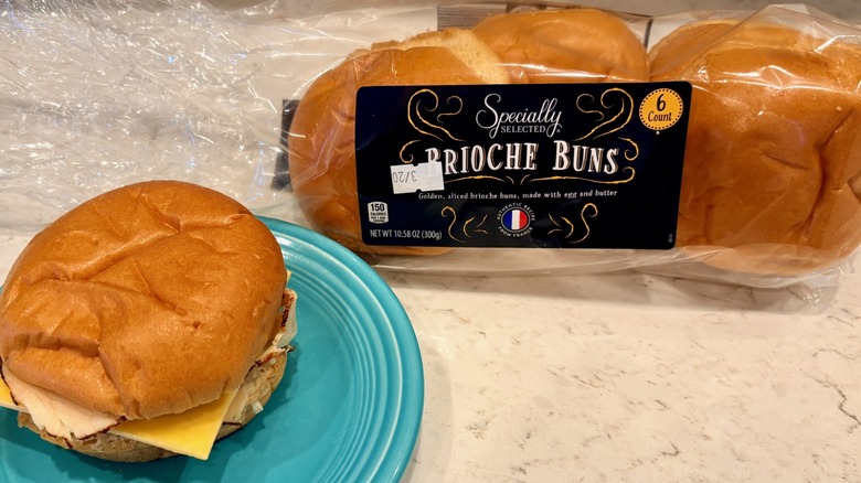 A sandwich and 6-count pack of Aldi Specially Selected brioche buns