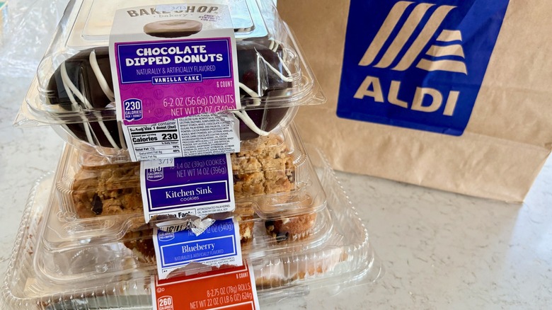 A stack of donuts, cookies, and muffins from the baked goods aisle at Aldi