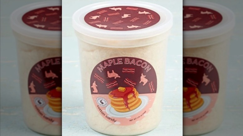 A plastic container of Maple Bacon Cotton Candy from Chocolate Storybook/Fairy Tale Cotton Candy.