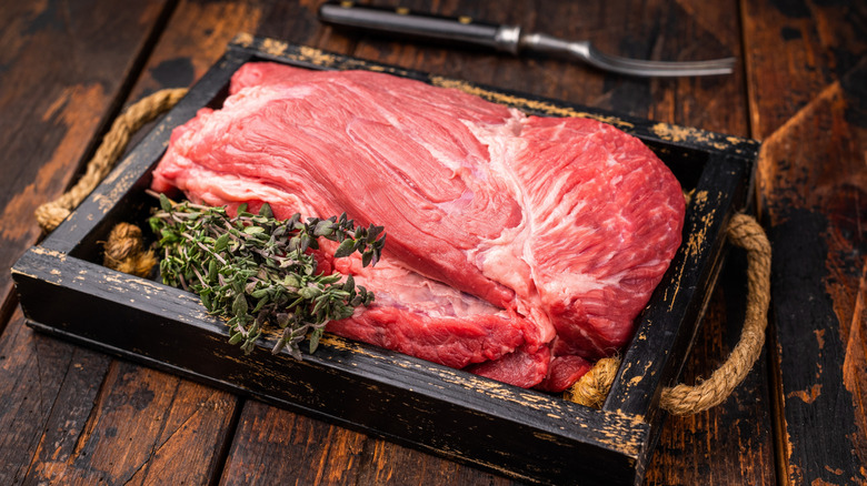 Uncooked Top Round beef, raw topround roast meat with thyme.