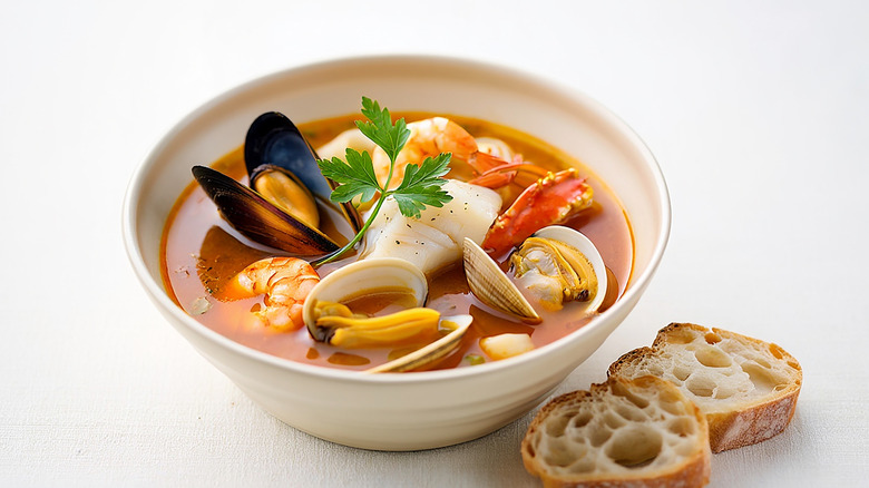 White bowl of Bouillabaisse with toast beside it
