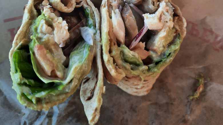 An Arby's Southwest Chicken Avocado Wrap sits on a wrapper