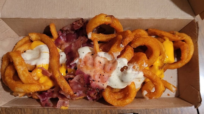 Arby's Loaded Curly Fries sit in a cardboard box
