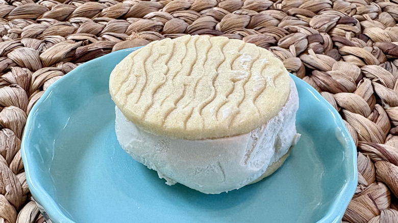 A FatBoy caramel cashew cookie sandwich in a dish