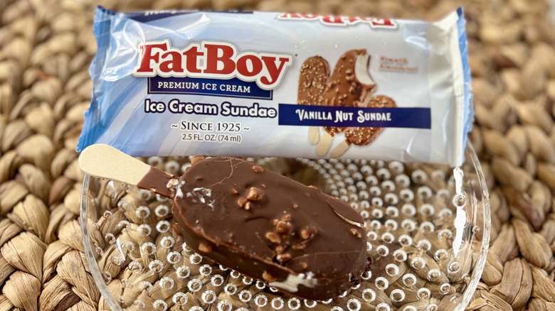 A FatBoy vanilla nut sundae bar on a plate with its wrapper