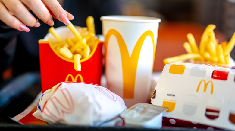A tray filled with fries, a drink and other items from McDonald's