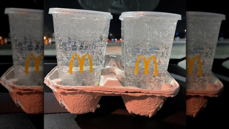 A drink carrier full with cups of Sprite from McDonald's