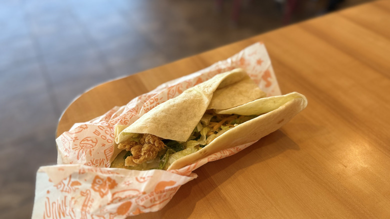 Popeyes Chicken Wrap in wrapping on a table