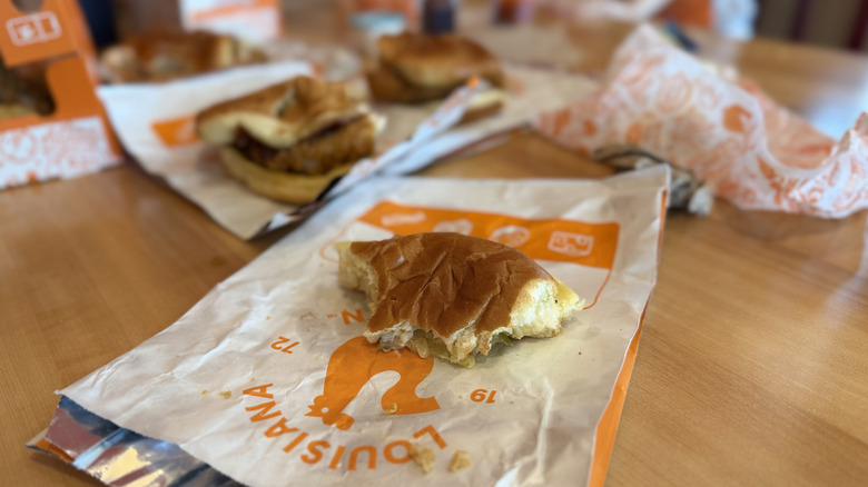 Partially eaten Popeyes chicken sandwich