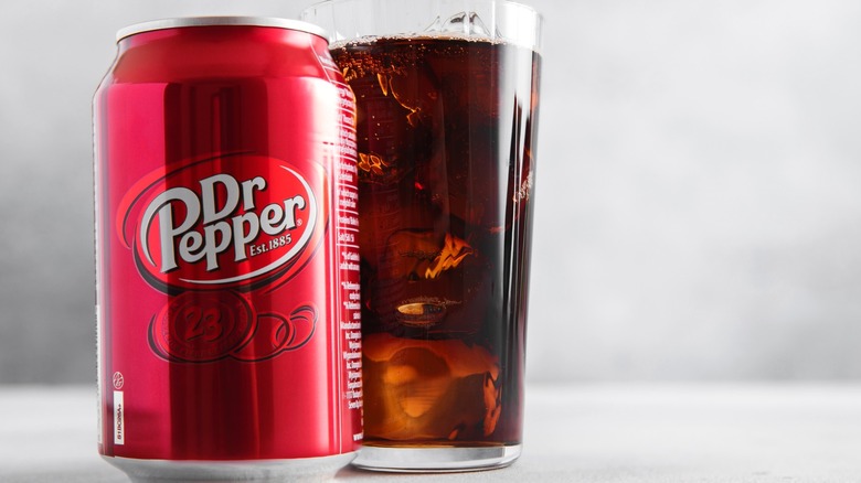 Dr Pepper soda can and glass on light table
