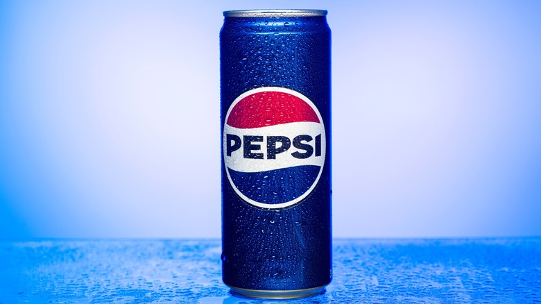 Can of Pepsi is sitting on a blue surface