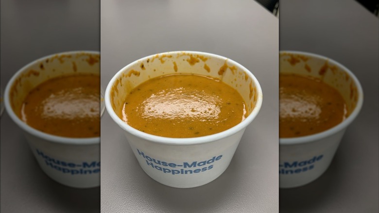 A to-go bowl of Cafe Zupas' Tomato Basil Soup