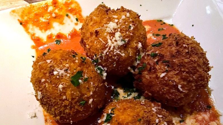 fork going into dish of The Cheesecake Factory mac and cheese balls