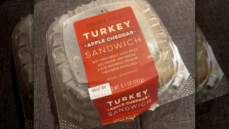 Trader Joe's Turkey Apple Cheddar Sandwich. sitting on a chair.