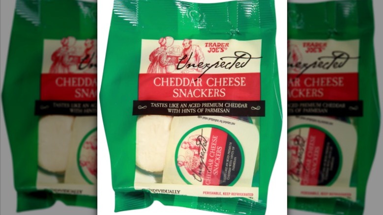 A bag of Trader Joe's Unexpected Cheddar Cheese Snackers on a white background.