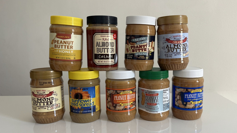 Nut butters are stacked on a white table