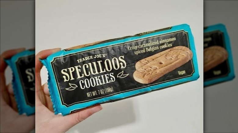 A hand holding Trader Joe's Speculoos Cookies.